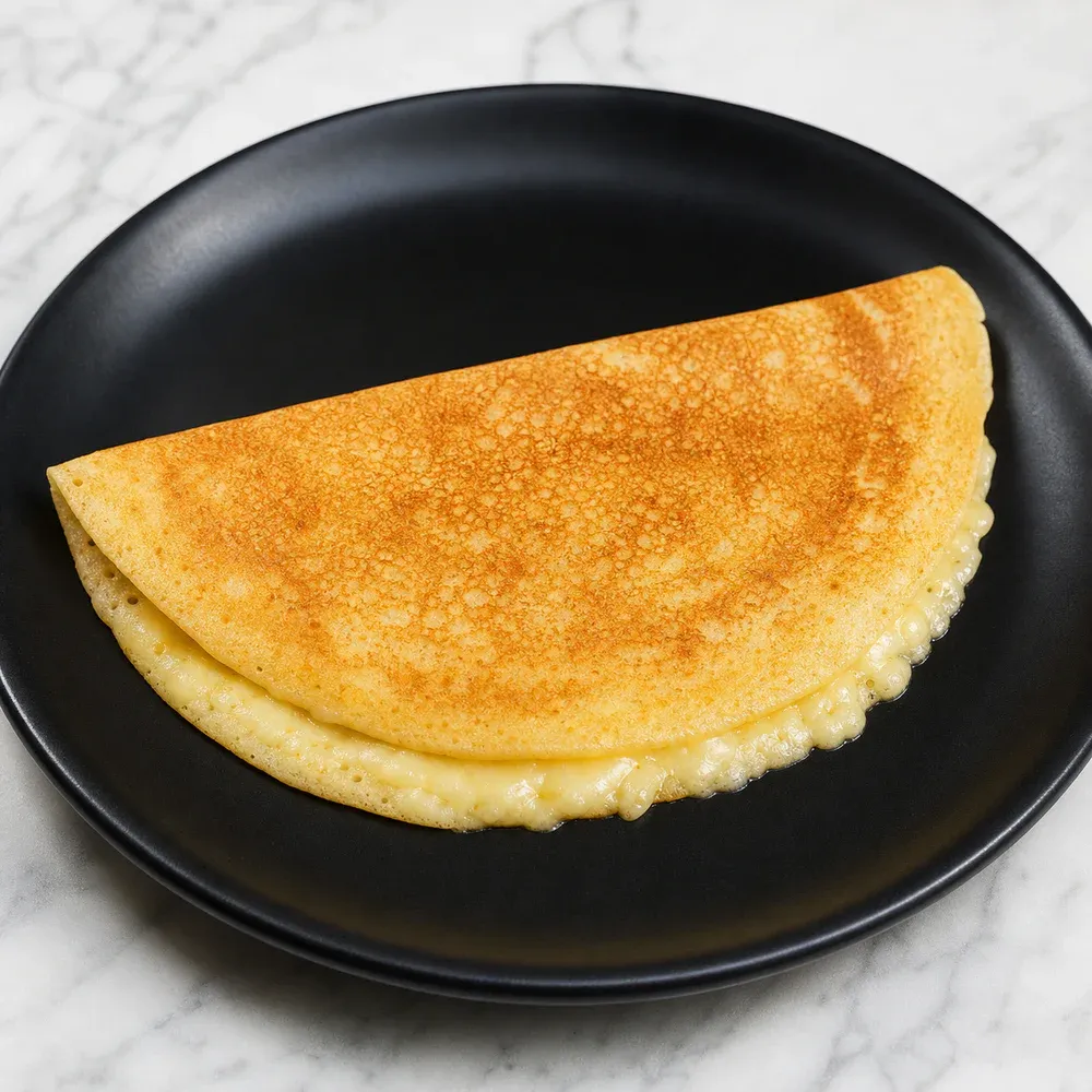 A kid-sized dosa filled with melted cheese.