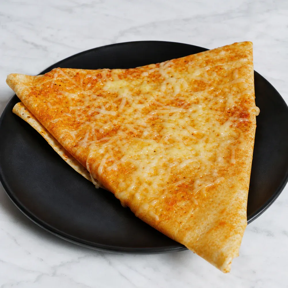 Dosa topped with mixed cheese.